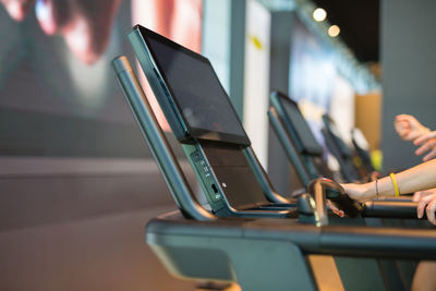 Midsection of woman using treadmill