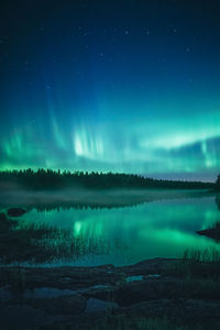 Scenic view of river against sky at night