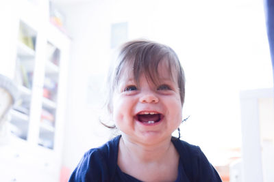 Cheerful cute baby girl at home