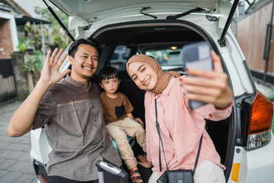 Portrait of smiling friends stacking hands