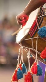 Close-up of person playing traditional drum