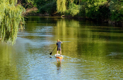 Full length of man surfing in lake