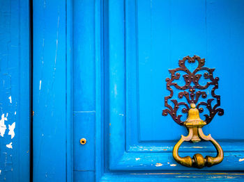 Close-up of knocker 
on closed door