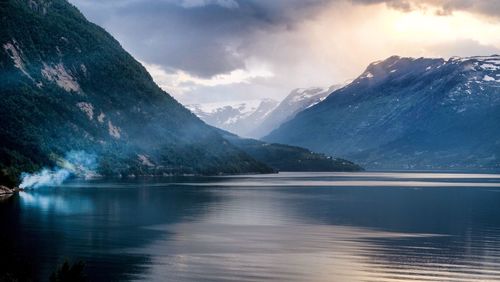 Scenic view of lake and mountains against sky