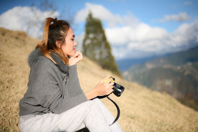 Young woman photographing with camera