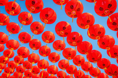 Low angle view of lanterns hanging on red lantern