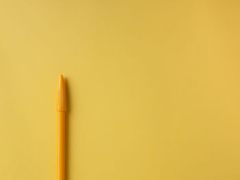 Close-up of pencils against yellow background