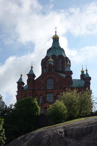 Low angle view of church against cloudy sky