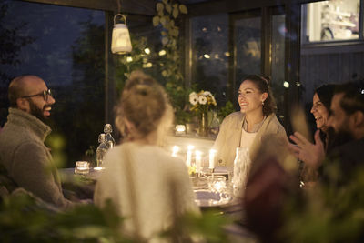 Happy friends having evening meal together