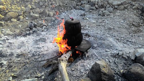 High angle view of bonfire on rock