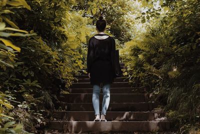 Rear view of a woman standing on steps