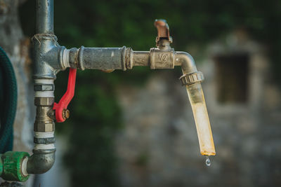 Close-up of faucet against blurred background