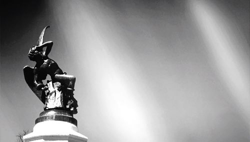 Low angle view of statue against sky