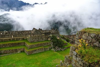 Scenic view of mountain against cloudy sky