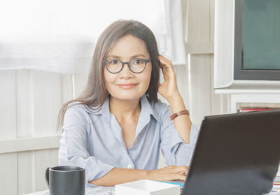 Portrait of woman using mobile phone