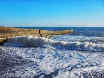 Scenic view of sea against clear blue sky