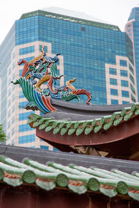 Low angle view of sculpture on building roof