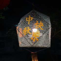 Low angle view of illuminated lanterns hanging at night