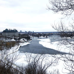 Scenic view of river against sky during winter
