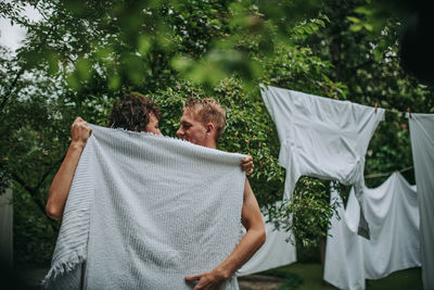 Rear view of man with umbrella on plants