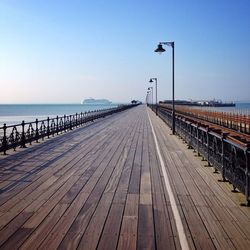 Pier on sea against clear sky