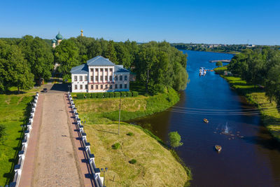 Scenic view of river amidst trees against blue sky