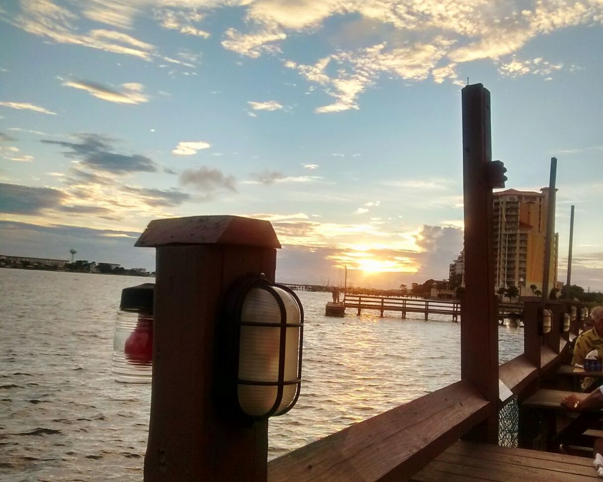 water, sunset, cloud - sky, scenics, built structure, wooden post, sky, architecture, river, travel destinations, tourism, tranquil scene, tranquility, nature, beauty in nature, vacations, dramatic sky, outdoors, sea, engineering, sun, mountain