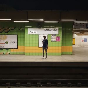 Full length of woman standing at railroad station