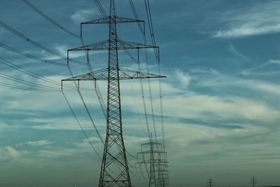 Low angle view of electricity pylon against sky