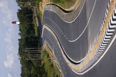 Empty zigzag road against sky