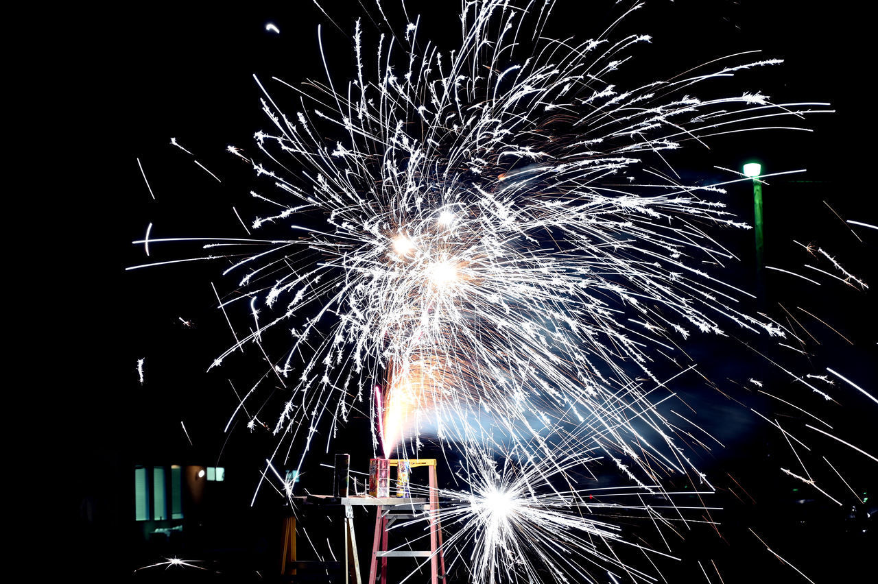 LOW ANGLE VIEW OF FIREWORKS DISPLAY AT NIGHT