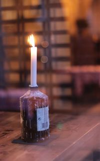 Close-up of illuminated candles on table