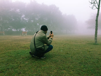 Men sitting in park during foggy weather