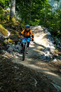 Woman riding a mountain bike on a flow trail in a bike park in glarus, switzerland.