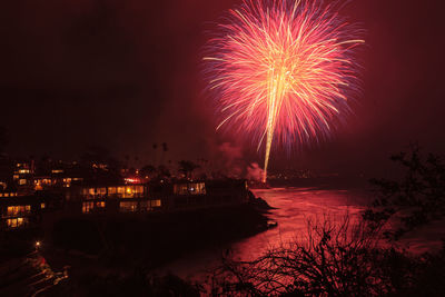 Firework display in city at night