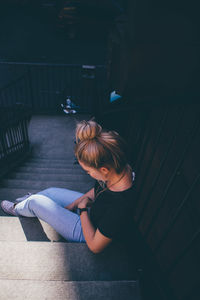 High angle view of depressed woman sitting on steps