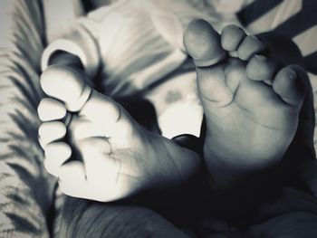 Close-up of baby feet on bed