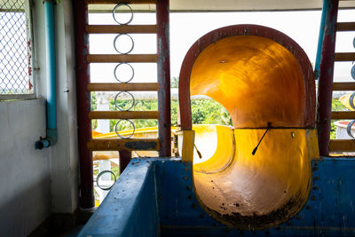 Close-up of yellow machine part in factory