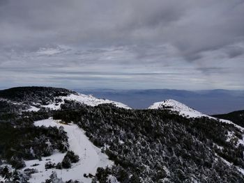 Scenic view of snow covered mountains against sky