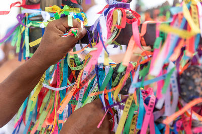 Severed hand of a person holding souvenir ribbons