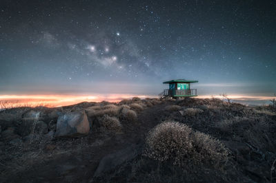 Built structure on land against sky at night