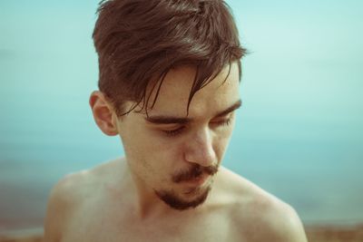 Close-up of a young man looking away