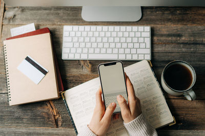 Businesswoman texting a message or note on a mobile phone.