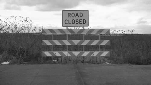 Road sign against sky