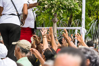 Catholic worshipers try to pick up bouquets of flowers during the corpus christ celebration 