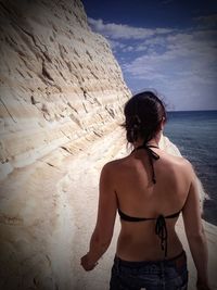 Rear view of woman at scala dei turchi by sea