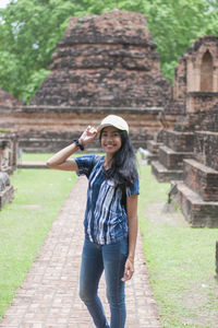 Portrait of smiling young woman standing outdoors