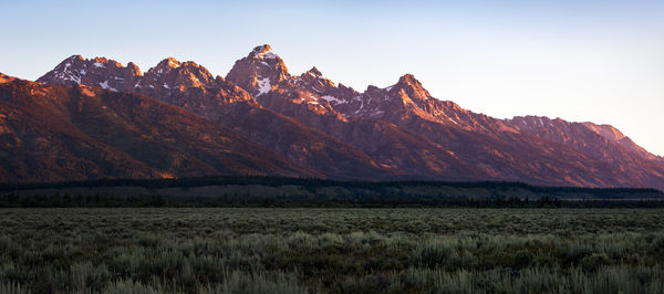 Scenic view of field and mountains during sunset