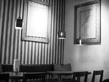 Empty chairs and table in illuminated room