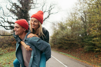 A young couple in love is fooling around on a walk. valentine's day concept.